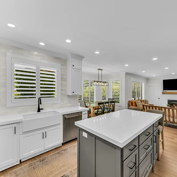 White Polywood shutters in a kitchen and living room area