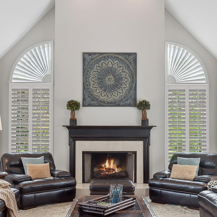 White Polywood shutters in a large living room with a fireplace
