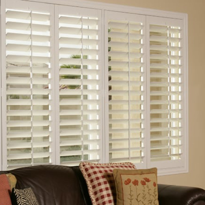 White plantation shutters in a living room.