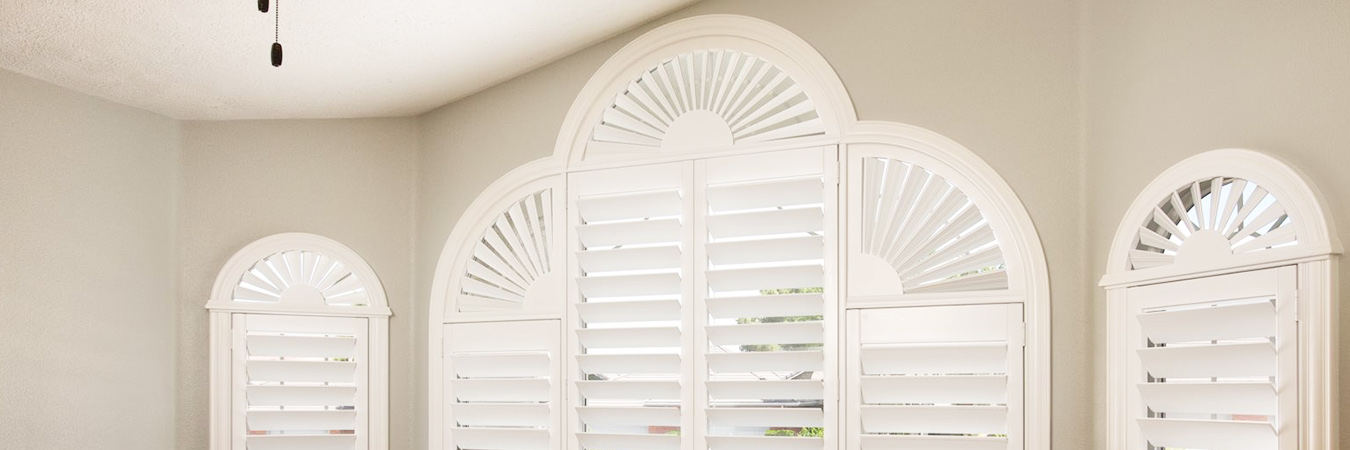 White polywood shutters special shaped within a bedroom