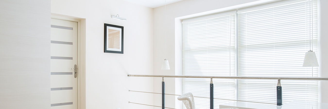 White loft room with white blinds.