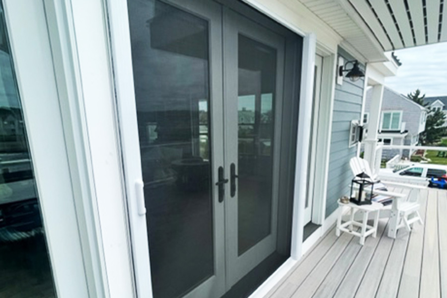 Retractable screen door in black with white trim