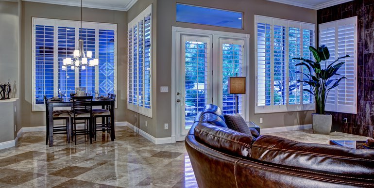 Photo Courtesy of Room Resolutions San Diego great room with plantation shutters and tile floor.