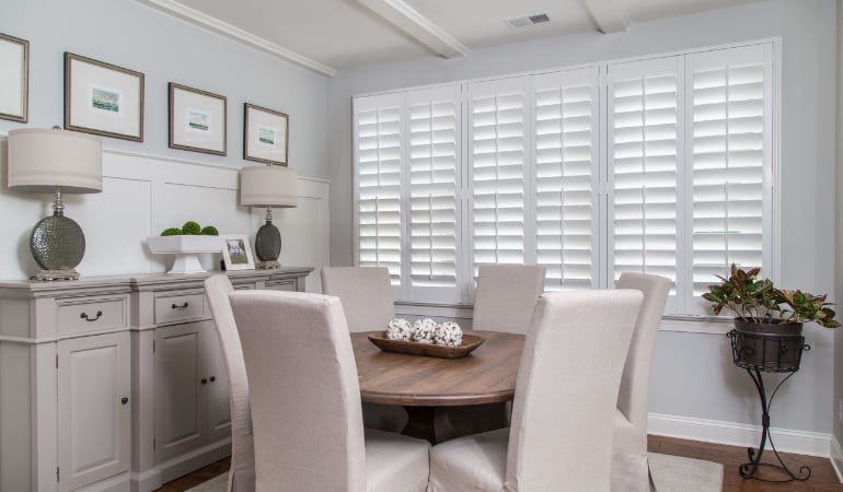 Plantation shutters are a perfect choice for homeowners looking for privacy or natural light. Plantation shutters in a San Diego dining room.