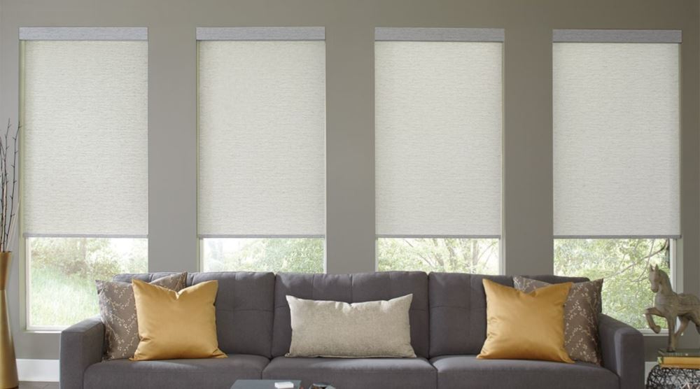 Motorized cordless window treatments above a couch