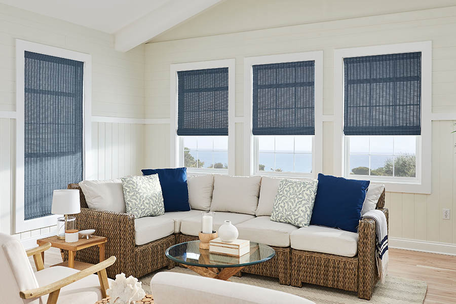 Want more color? Window shades are your most colorful window treatment option. Blue natural fiber shades on living room windows