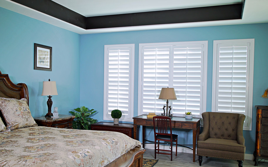 Polywood shutters provide insulation for the perfect temperature all year long in San Diego. Polywood shutters in a bedroom.
