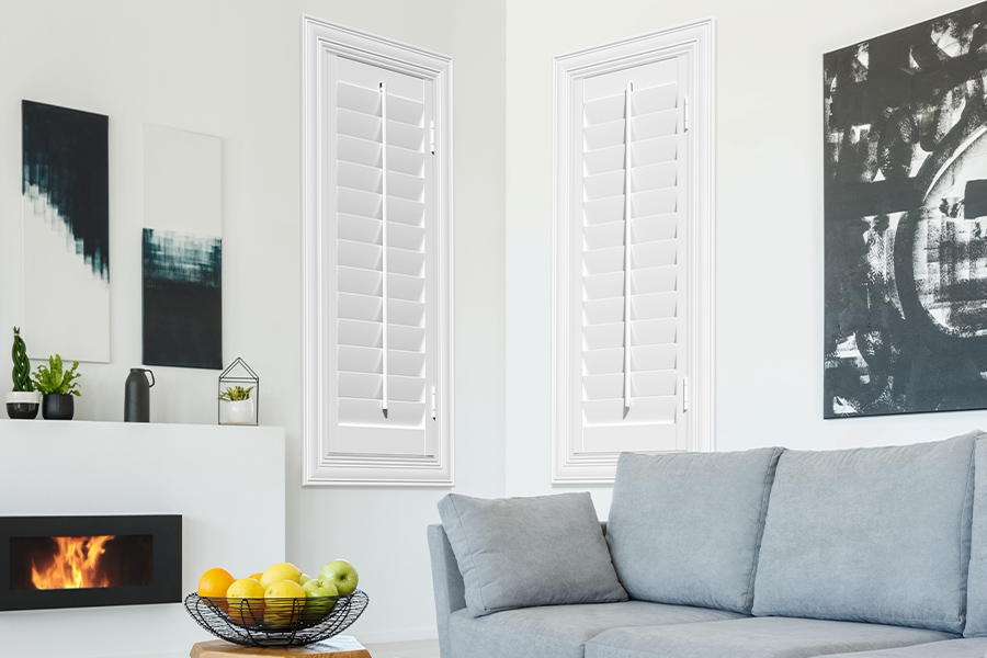 White Polywood shutters add character and class in San Diego. White polywood shutters in a corner of a modern living room.