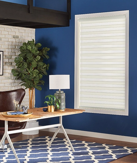 industrial decor with sheer white shade within a tall window next to a dining room area