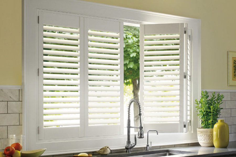 Polywood shutters are built to withstand the test of time in San Diego. White Polywood shutters above a kitchen sink.